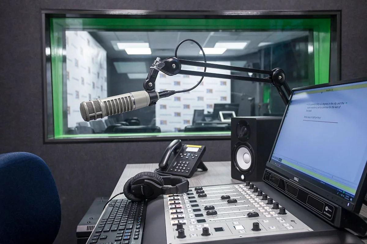 WABMA's broadcast studio with mixing console, microphones and headphones